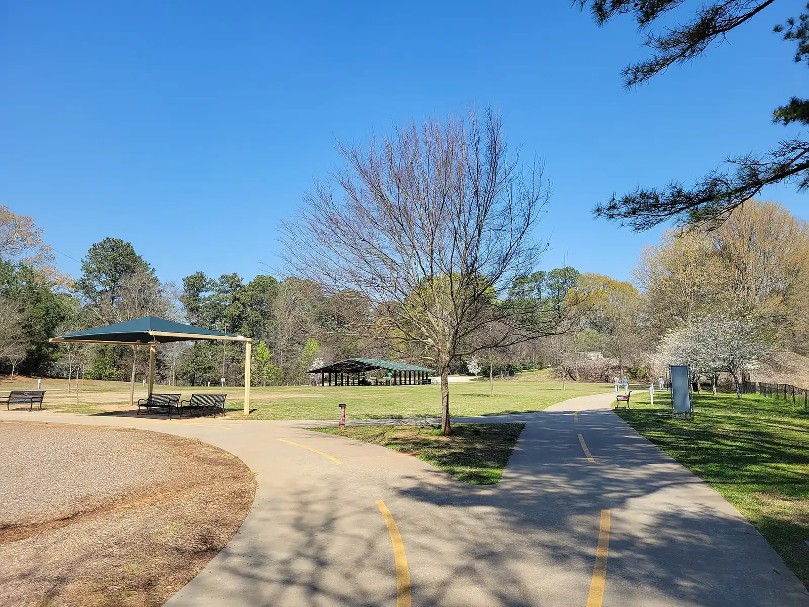 The paved walking path and picnic shelters in Blackburn Park, which also has a playground and a tot lot