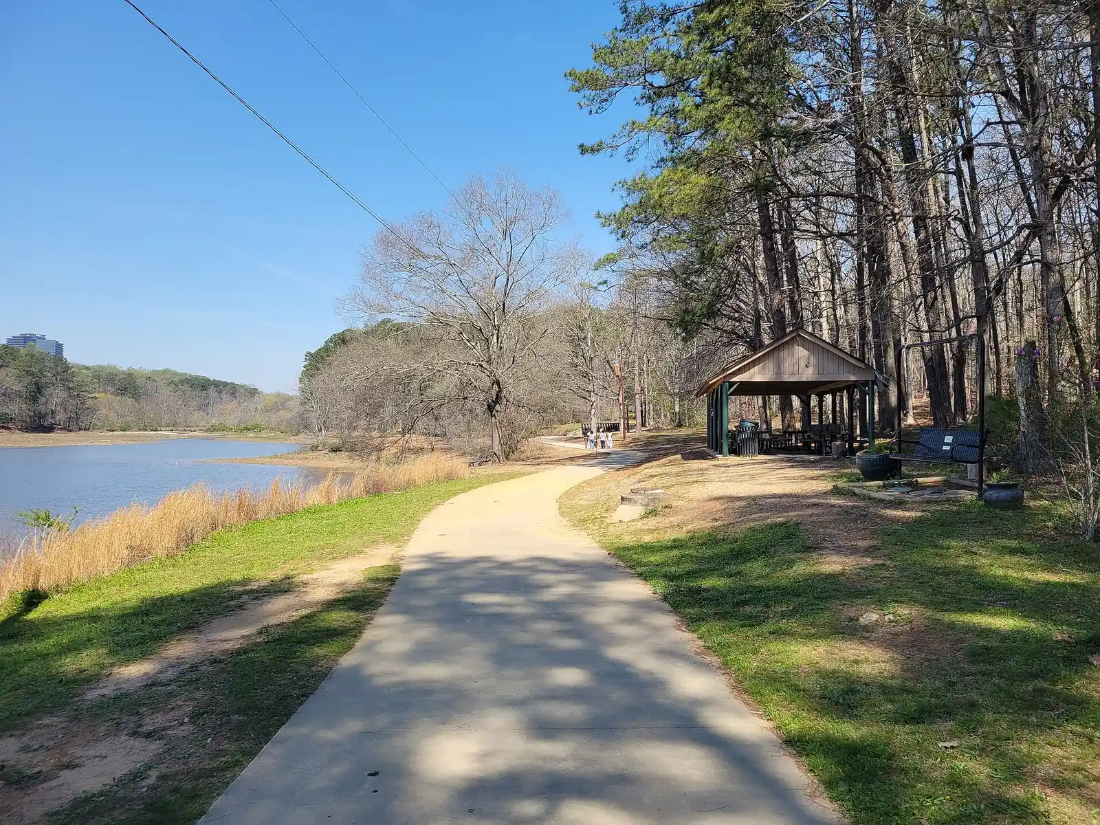 The paved walking path beside the lake in Murphey Candler Park