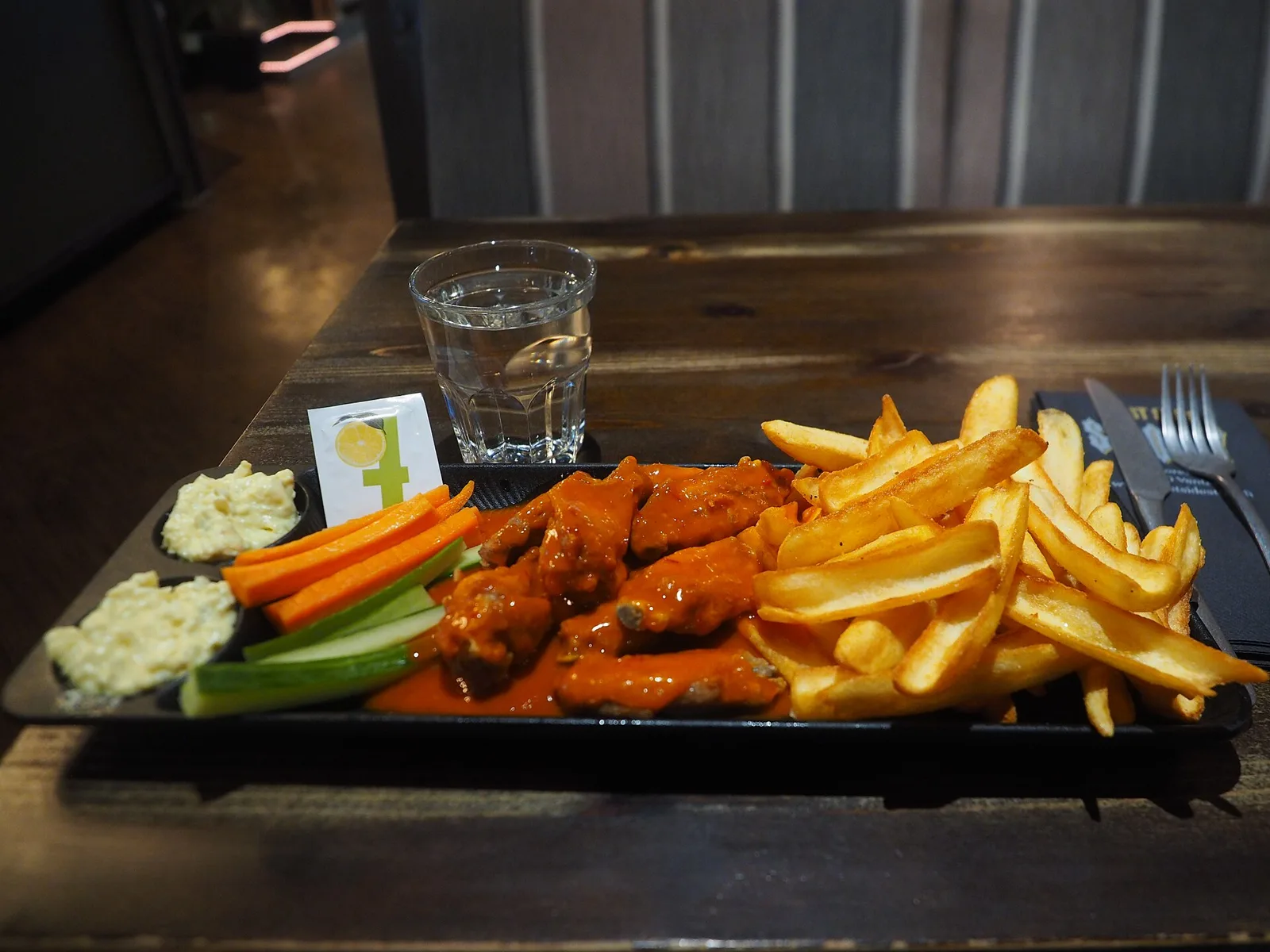 A plate of chicken wings with fries and blue cheese dip. The photo was not taken at a Brookhaven restaurant.